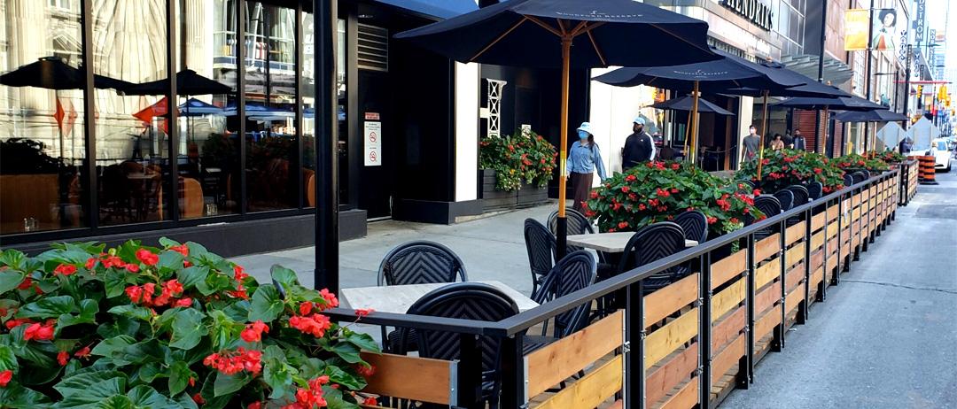 Standard street patio example with rails and umbrellas